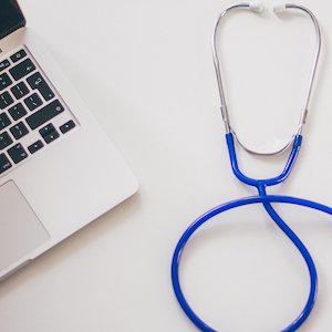 Stethoscope next to laptop