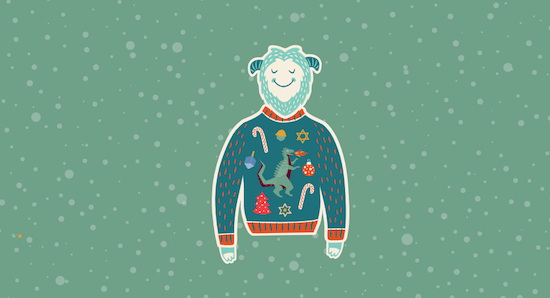 Happy, teal monster wearing a custom ugly holiday sweater