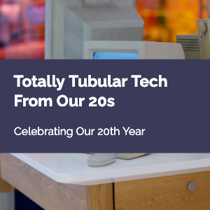 A vintage desktop computer sits on a white desk. Text reads: Totally Tubular Tech From Our 20s