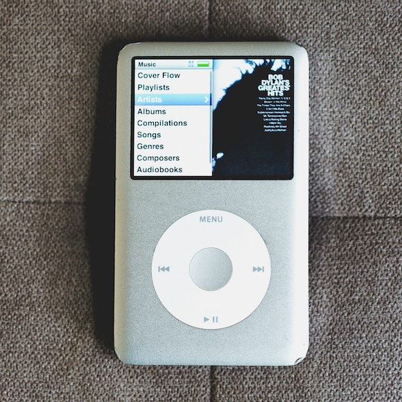 An iPod sits on a gray cushion