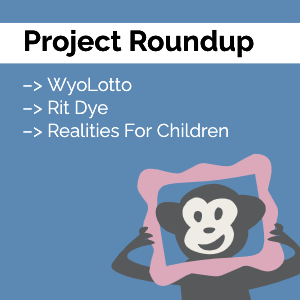 Our monkey mascot Randall looking through a pink picture frame with the words "Project Roundup" at the top
