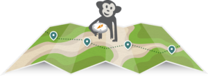 Randall the monkey is holding a compass and sitting on a paper map