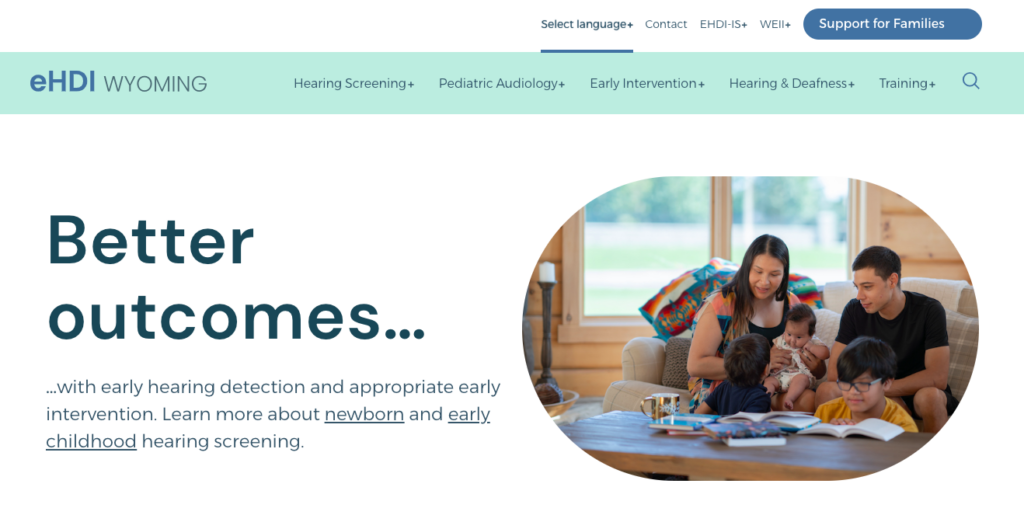 Homepage for Wyoming eHDI. The hero image is a woman and a man sitting on a sofa playing with two children and a baby.