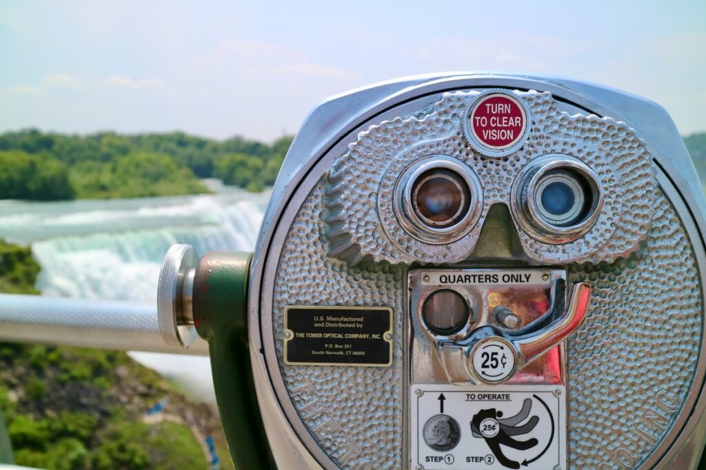 Gray and black coin-operated binoculars looking out toward Niagara Falls