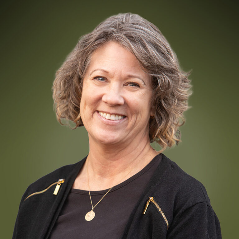 Cathy Potter in a black shirt and gold necklace.